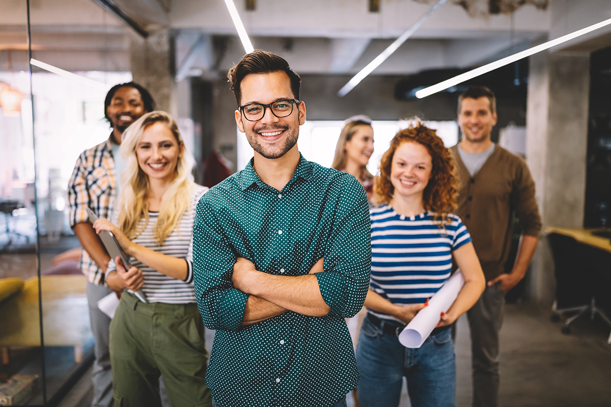 smiling diverse employees, representing success by a recruitment marketing agency in attracting white-collar employees